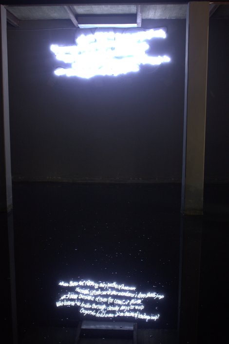 The writing on the wall reflected in the water on the floor. Only in the reflection could you read its poetry.